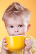 Funny boy drink from yellow cup