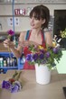 Florist arranges flowers in a vase