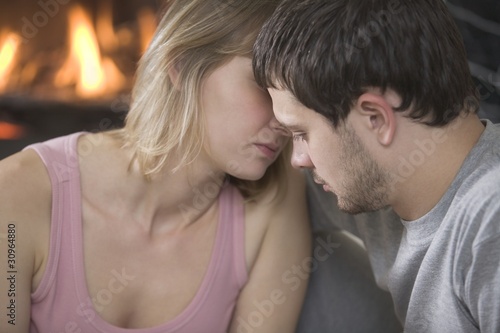 Photo: Young couple kiss by open fire Young couple kiss by open fire