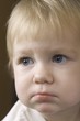 Blonde 14 month old with downcast expression