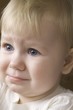 Blonde 14 month old on the verge of tears