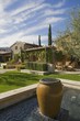 Exterior of a house, with a garden, plants and a water feature