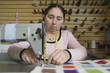Mature woman sewing in the laundrette