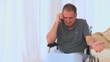A male in a wheelchair having a phone call A male in a wheelchair having a phone call