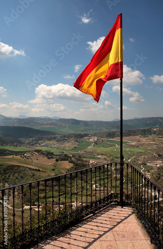Photo: Spanish flag flying over the beautiful town of Ronda Spanish flag flying over the beautiful town of Ronda
