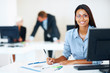 Smiling young business woman at office desk Smiling young business woman at office desk