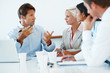 Successful businessman guiding his associates in a meeting Successful businessman guiding his associates in a meeting