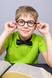 Adorable elementary holding his glasses