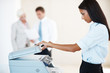 Attractive young woman photocopying at the office