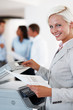 Business woman taking out a Xerox copy Business woman taking out a Xerox copy