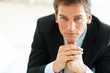 Confident young businessman staring at you