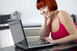 Young female working from home in the kitchen.