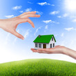 House in the hands against the blue sky House in the hands against the blue sky