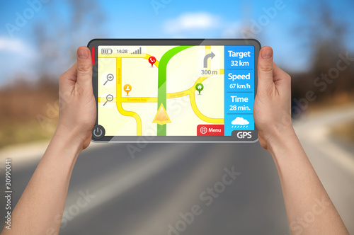 Photo: a male hand holding a gps a male hand holding a gps