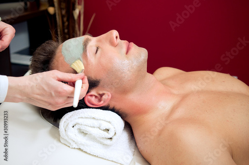 Photo: Handsome man with mud mask on his face Handsome man with mud mask on his face