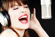 expressive woman singing to the microphone