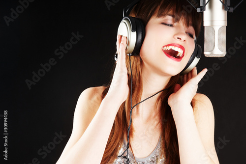 Photo: popstar singing to the microphone popstar singing to the microphone