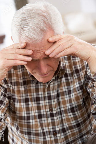 Photo: Senior Man Looking Stressed In Chair At Home Senior Man Looking Stressed In Chair At Home