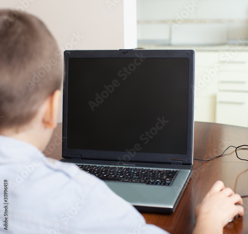 Photo: Boy playing a computer Boy playing a computer