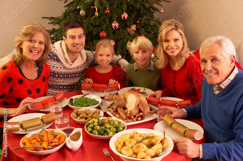 Photo: Three Generation Family Enjoying Christmas Meal At Home Three Generation Family Enjoying Christmas Meal At Home