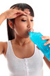 Exhausted girl drinking after fitness exercise workout