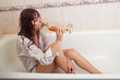 young red-haired woman in shower drinks alcohol