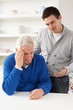 Grown Up Son Consoling Senior Parent