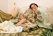 girl sits on his bed. Linens, bedding