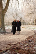 Senior Couple On Winter Walk Through Frosty Landscape