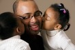 Girls Kissing Daddy On The Cheek