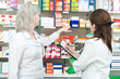 Pharmacy chemist women in drugstore