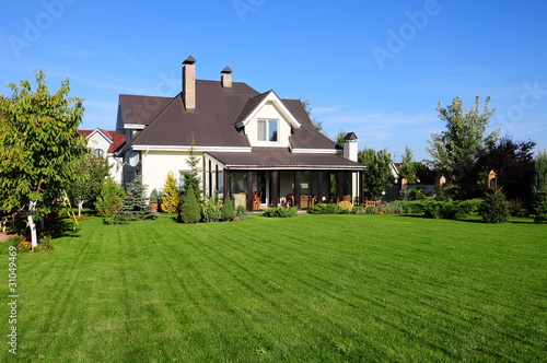 Photo: A new house with a garden in a rural area A new house with a garden in a rural area