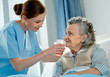Photographie : Nurse cares for a elderly woman lying in bed