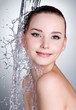 Smiling woman under stream of water