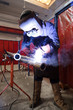 worker weld metal in factory and sparks