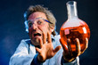 Mad Scientist extending explosive concoction away from his face