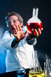 Mad Scientist extending explosive concoction away from his face