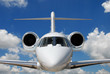 Private jet against blue sky and clouds