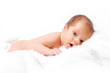 Newborn baby laying on the white blanket