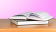 Open book on desk  on pink background