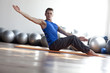 man practicing pilates in light gym
