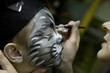 The boy makes a children's make-up