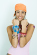 Photo: Teen girl wearing lots of accessories, holding up forearms, smiling at camera, portrait Teen girl wearing lots of accessories, holding up forearms, smiling at camera, portrait