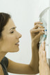 Woman pushing lever in fuse box