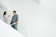 Young woman standing speaking with architect, low angle view