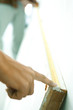 Photo: Two people holding measuring tape along length of door turned on its side, close-up of hand Two people holding measuring tape along length of door turned on its side, close-up of hand