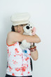 Teenage girl embracing stuffed toy, smiling at camera, portrait