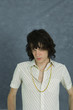 Teenage boy looking at camera, head down, portrait