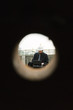 Building contractor working at construction site, seen through hole
