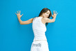 Photo: Woman in pants with the word truth" on backside, standing with hands against wall, looking over shoulder at camera" Woman in pants with the word truth" on backside, standing with hands against wall, looking over shoulder at camera"